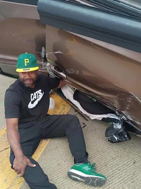 man holds womans hand car crash