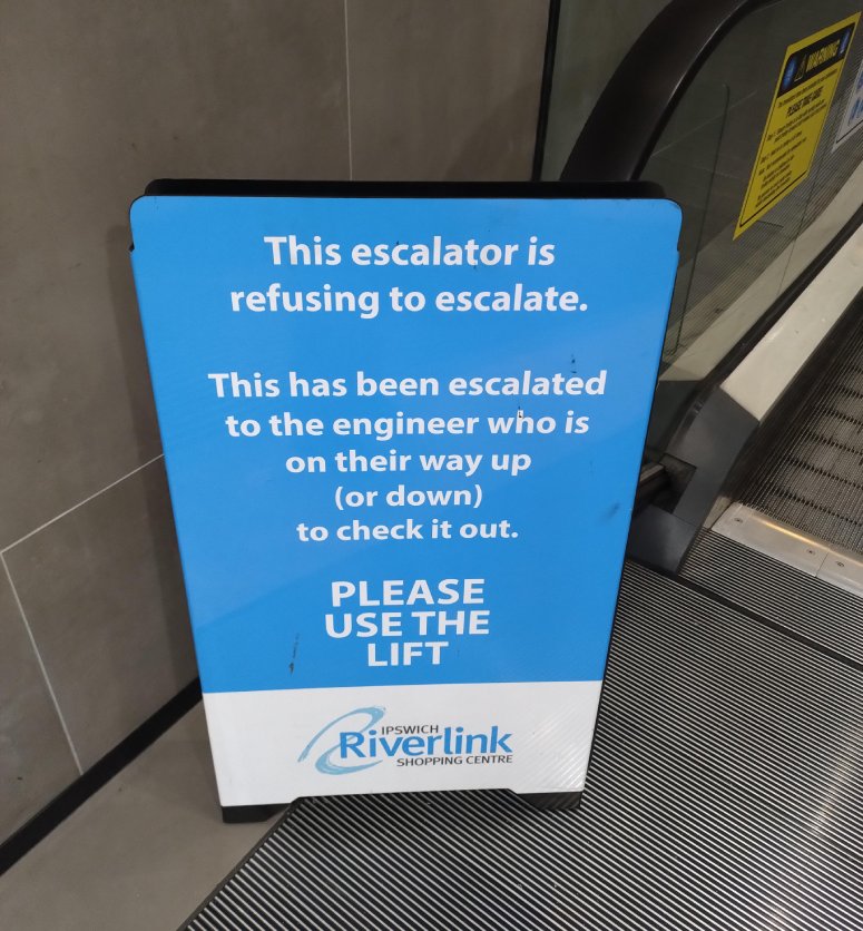 funny escalator sign