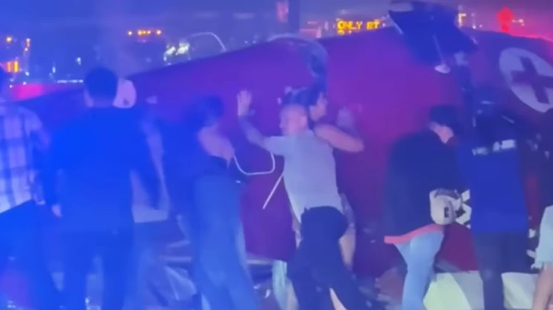 people lift crashed helicopter