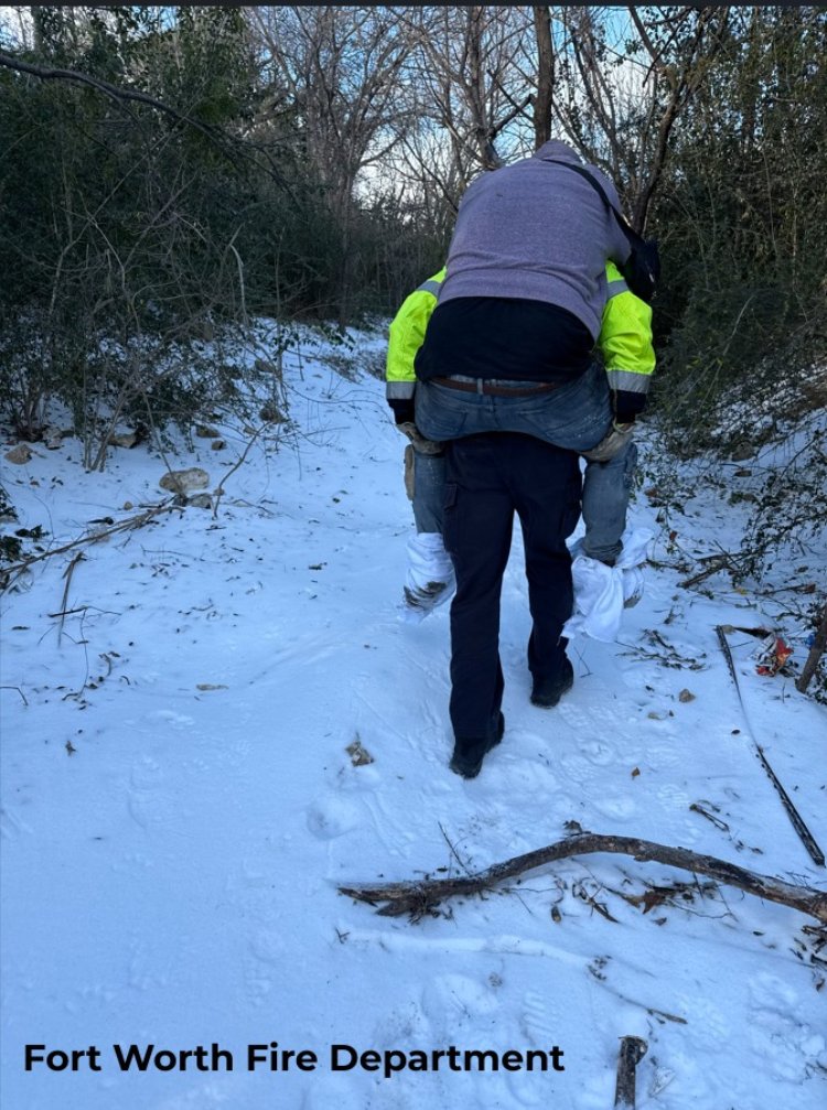 firefighter carries homeless man in snow