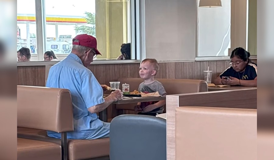 little boy sits with older man McDonalds